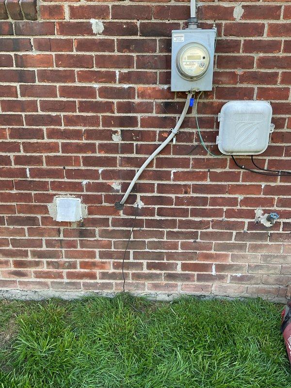 Completed comprehensive whole home electrical inspection to diagnose flickering lights issue. Performed visual assessment of exterior electrical service equipment, including meter base, weatherhead connections, and service entrance conductors. Inspected condition of utility service drop and clearance from tree branches, noting significant vegetation contact with structure that could affect overhead service lines. Evaluated exterior junction boxes, conduit routing, and grounding system integrity. Documented all findings with photographs for customer records and future reference.