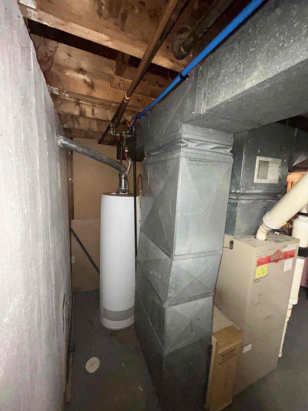 Conducted comprehensive full system estimate for residential HVAC replacement in basement installation. Evaluated existing 16-year-old furnace and air conditioning system, both requiring replacement due to age and operational inefficiency. Assessed basement utility area layout, existing ductwork configuration, venting infrastructure including current PVC exhaust piping, and available clearances for new equipment installation. Documented current forced-air heating system, sheet metal ductwork distribution network, and spatial constraints including proximity to water heater and stored items. Provided replacement options and recommendations for complete furnace and central air conditioning system upgrade to meet customer's timeline of replacement within one month.