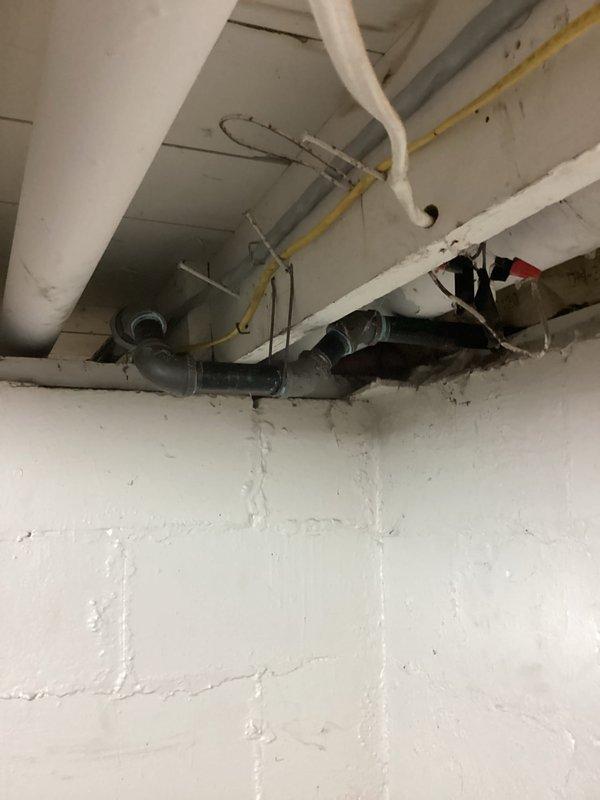 Installed 1-inch gas pipe from existing utility connection point on exterior wall through basement to prepare for new gas meter installation by utility company. Routed new gas line along basement ceiling joists following proper code requirements and secured with appropriate hangers, positioning line for future tankless water heater connection once utility company completes meter upgrade.