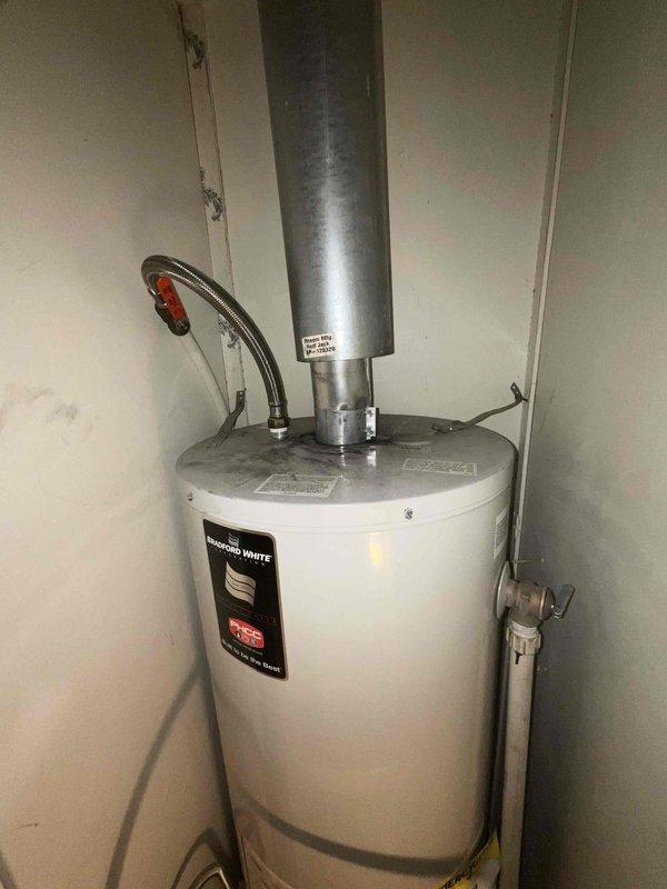 Responded to service call for non-functional Bradford White standard tank water heater. Assessed existing unit installed in utility closet with atmospheric venting system and copper supply lines. Provided estimate for replacement of failed water heater with new standard tank unit, including necessary connections to existing gas line, water supply piping, venting system, and code-compliant installation with required safety devices and shut-off valves.