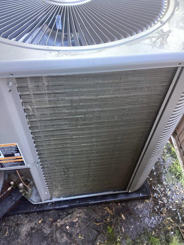 Completed annual AC tune-up maintenance on a 16-year-old Lennox system. Performed comprehensive inspection and cleaning of outdoor condenser unit, which showed significant accumulation of dirt, debris, and mineral deposits on coil surfaces. Thoroughly cleaned condenser coils to restore proper airflow and heat transfer efficiency. Inspected fan guard, refrigerant lines, and electrical components. System tested and confirmed operational with no issues found.