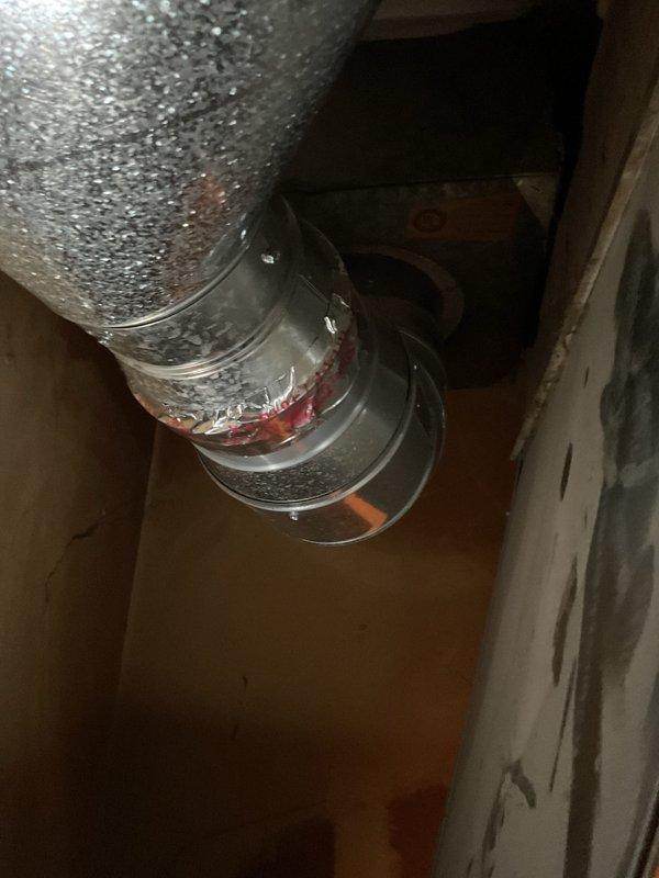 Completed installation of 70,000 BTU Yukon furnace and 2-ton air conditioning system with rear discharge configuration. Installed new ductwork connections in attic space using flexible and rigid metal ducting with proper sealing and support. Unit positioned in utility closet with exhaust venting routed through existing opening, exploring installation method that minimizes chimney modifications per callback assessment.