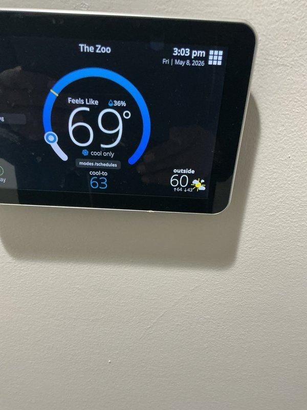 Completed spring maintenance tune-up on residential HVAC system. Performed comprehensive inspection of heating and cooling equipment, verified smart thermostat operation showing proper temperature control at 69°F in cooling mode, and inspected dual air filters in return air plenum which showed clean condition with minimal dust accumulation. System confirmed operational and running efficiently with no deficiencies noted.