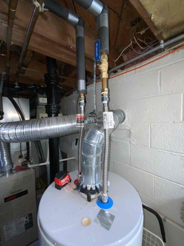 Provided comprehensive estimate for complete HVAC system replacement in basement location, including 30-year-old natural gas furnace and air conditioning unit, along with 2011 water heater. Current equipment operational but nearing end of service life. Documented existing Amana furnace installation with aluminum ductwork, water heater with expansion tank and PVC venting, and assessed utility room layout for replacement equipment specifications and installation requirements.