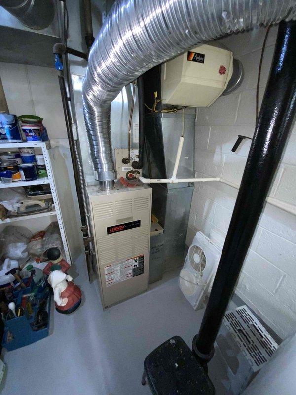 Provided comprehensive estimate for complete HVAC system replacement in basement location, including 30-year-old natural gas furnace and air conditioning unit, along with 2011 water heater. Current equipment operational but nearing end of service life. Documented existing Amana furnace installation with aluminum ductwork, water heater with expansion tank and PVC venting, and assessed utility room layout for replacement equipment specifications and installation requirements.