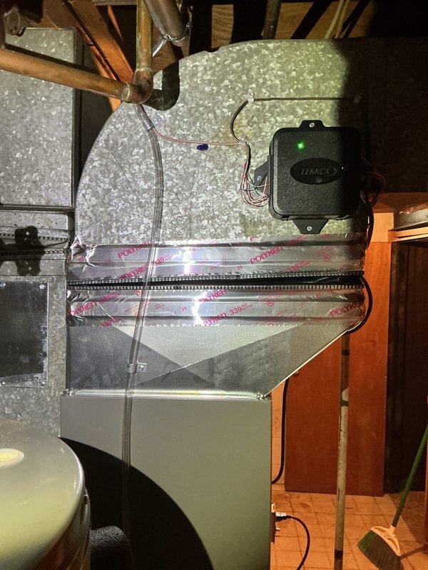 Completed installation of 2-ton air conditioning system with evaporator coil in attic space. Installed Lennox control unit with ductwork connection, properly secured all electrical connections, and reconnected existing electrical service. All components tested and verified operational with system running within manufacturer specifications.