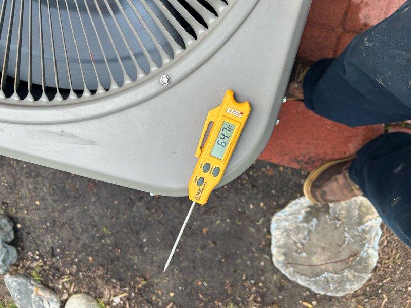 Completed routine air conditioning maintenance visit on residential cooling system. Performed operational diagnostics including temperature measurements at outdoor condensing unit, which registered 67.1°F at time of inspection. Unit found in functional condition with fan assembly operating properly and no immediate service concerns identified.