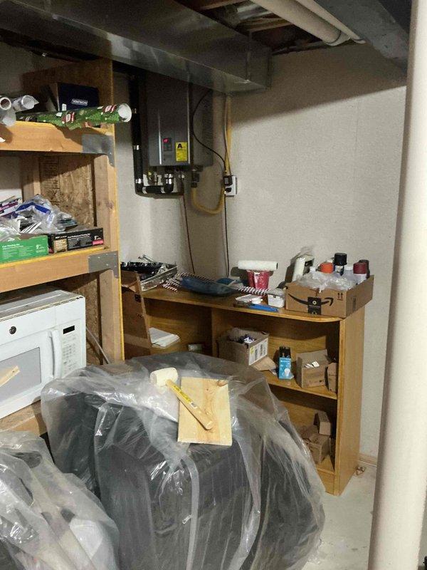 Conducted on-site assessment for tankless water heater replacement in residential property. Evaluated existing tankless unit location in basement utility area and verified electrical panel capacity and gas line accessibility for new installation. Documented current installation configuration including venting requirements, clearances, and utility connections to provide accurate replacement specifications and ensure code-compliant installation of new tankless water heating system.