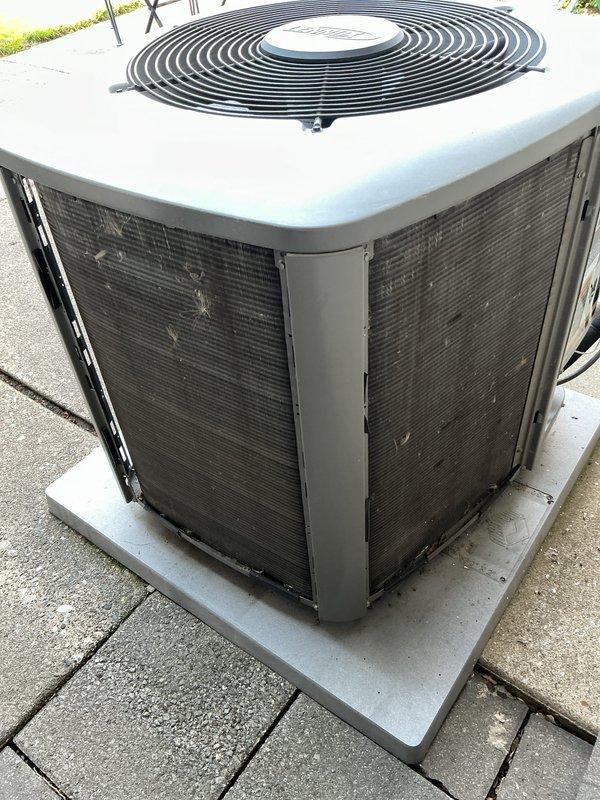Performed annual cooling maintenance on residential outdoor condensing unit. Inspected condenser coils, fan operation, and electrical connections. Unit operating within normal parameters on concrete pad with adequate clearance. Noted filter replacement requirement for two locations at indoor air handler positions.
