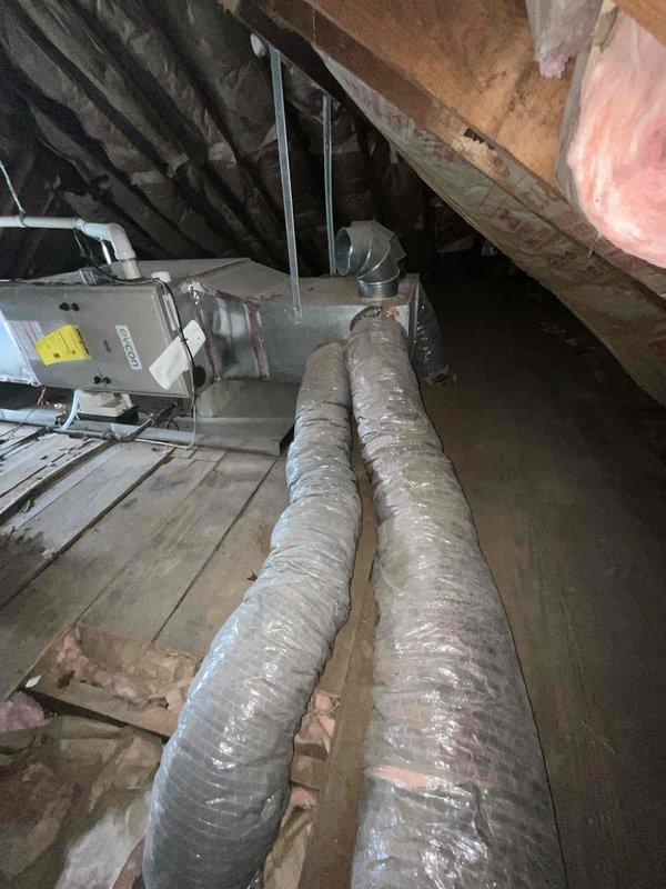 Conducted comprehensive assessment of two existing air conditioning systems for replacement estimate. One furnace unit located in basement, second HVAC system positioned in attic space with air handler and associated ductwork. Both current units operational at time of inspection. Evaluated attic installation including existing flexible ductwork, air handler unit, condensate drain lines, and accessibility for future replacement. Documented equipment specifications, spatial constraints, and existing infrastructure to provide accurate replacement recommendations for dual-system residential HVAC upgrade.