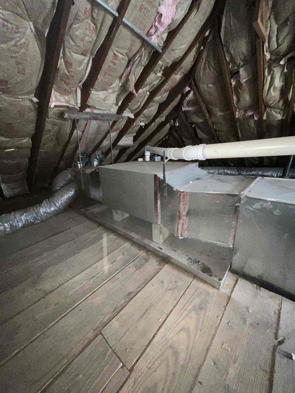 Conducted comprehensive assessment of two existing air conditioning systems for replacement estimate. One furnace unit located in basement, second HVAC system positioned in attic space with air handler and associated ductwork. Both current units operational at time of inspection. Evaluated attic installation including existing flexible ductwork, air handler unit, condensate drain lines, and accessibility for future replacement. Documented equipment specifications, spatial constraints, and existing infrastructure to provide accurate replacement recommendations for dual-system residential HVAC upgrade.