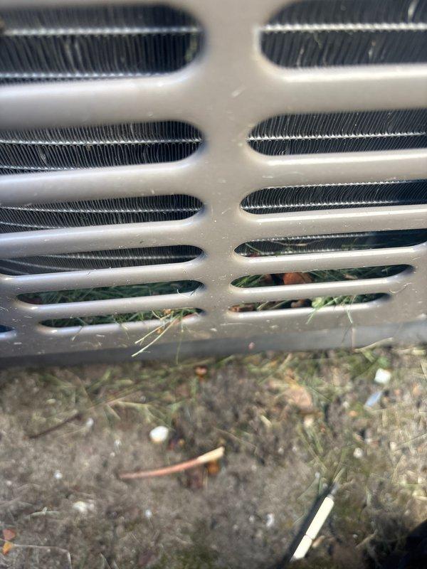 Completed annual preventive maintenance on rooftop cooling unit. Inspected condenser coils and exterior grille assembly, noting minor dust accumulation on protective louvers and heat exchanger fins. Unit operating within normal parameters with all components functioning properly at time of service.