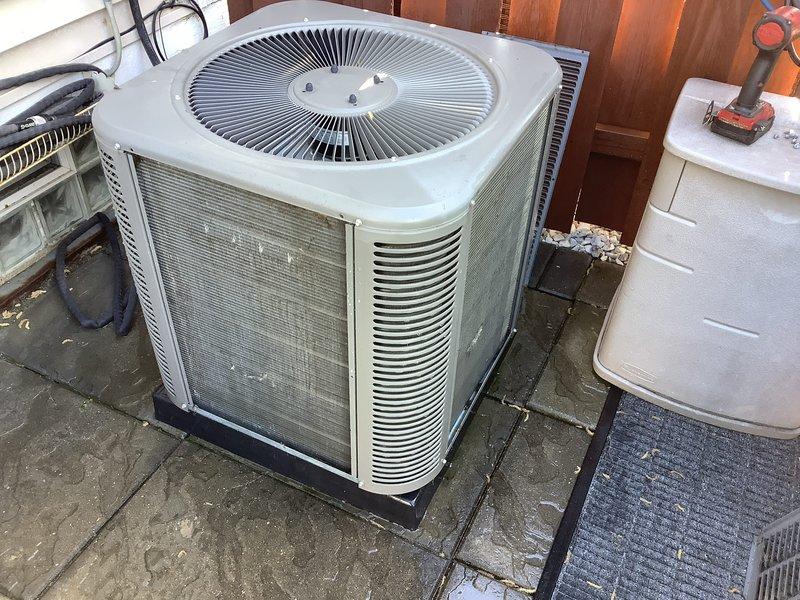 Performed annual cooling maintenance on residential outdoor condensing unit. Completed comprehensive system inspection, cleaned condenser coils and exterior surfaces showing weathering and discoloration, verified refrigerant lines and connections, tested fan motor operation, and confirmed unit operational status with all components functioning within normal parameters.
