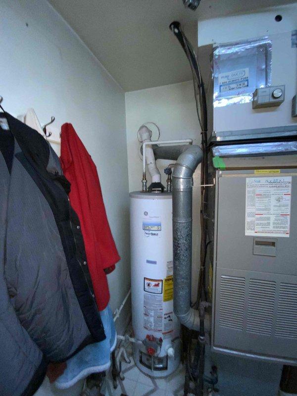 Provided estimate for replacement of 25-year-old natural gas furnace and water heater located in main level mechanical room. Current water heater is non-operational while furnace remains functional. Equipment is installed in confined utility closet with existing PVC venting and requires replacement due to age and water heater failure.