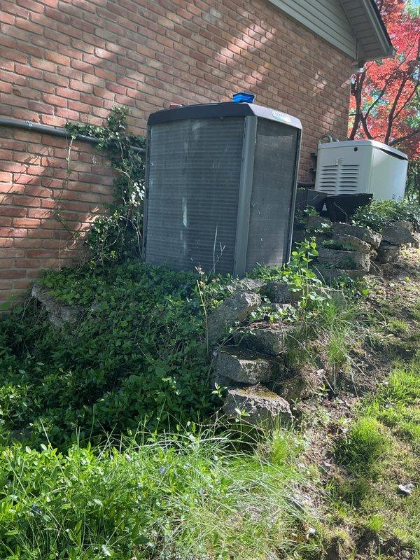 Completed scheduled air conditioning maintenance on residential Lennox condenser unit. Inspected system components, replaced air filter, and documented equipment condition with photos showing unit properly positioned against exterior brick wall with adequate clearance for airflow and service access.