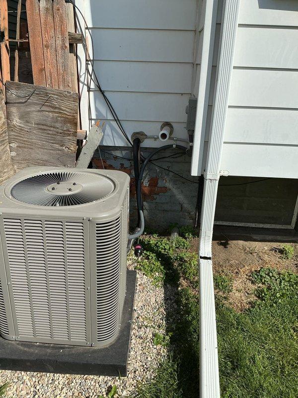 Completed callback to address code violation from original installation of 70,000 BTU furnace and 2-ton air conditioning system. Properly secured NM cable supporting exterior receptacle to meet electrical code requirements. Verified all exterior electrical connections, conduit routing, and refrigerant line installations are compliant with permit specifications.