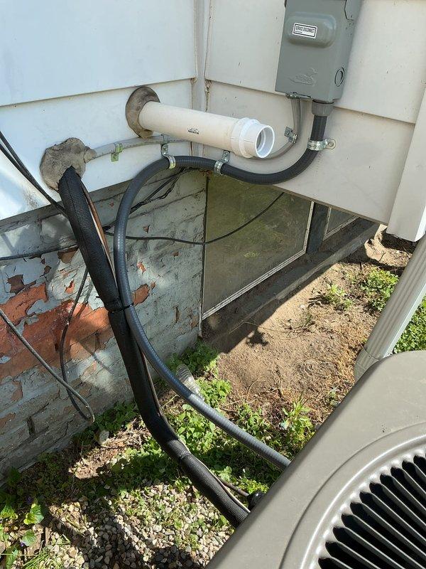 Completed callback to address code violation from original installation of 70,000 BTU furnace and 2-ton air conditioning system. Properly secured NM cable supporting exterior receptacle to meet electrical code requirements. Verified all exterior electrical connections, conduit routing, and refrigerant line installations are compliant with permit specifications.