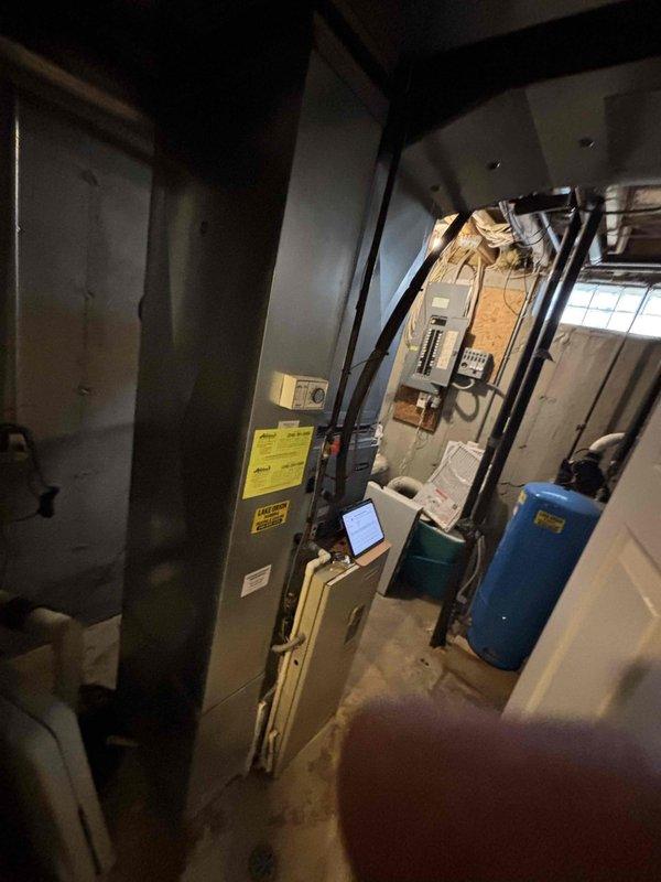 Completed site assessment for non-functional air conditioning system in basement mechanical room. Documented existing HVAC equipment configuration, electrical service panel locations, and utility infrastructure to prepare comprehensive replacement estimate for aging AC unit.