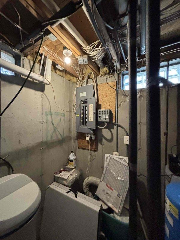 Completed site assessment for non-functional air conditioning system in basement mechanical room. Documented existing HVAC equipment configuration, electrical service panel locations, and utility infrastructure to prepare comprehensive replacement estimate for aging AC unit.