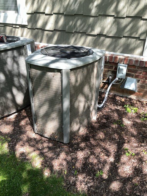 Completed annual preventive maintenance on two outdoor air conditioning condenser units. Performed comprehensive inspection of both systems including cleaning condenser coils, checking refrigerant lines and insulation, verifying electrical connections at disconnect boxes, and testing fan operation. All components found to be in proper working condition with no issues identified during the routine maintenance visit.