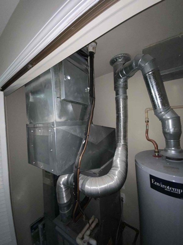Provided estimate for replacement of 10+ year old furnace and air conditioning system located on second floor utility space. Current AC unit not operational. Quote prepared for natural gas furnace and AC replacement under BOGO promotion, with existing installation featuring compact utility room configuration including water heater and ductwork routing through slanted ceiling space.