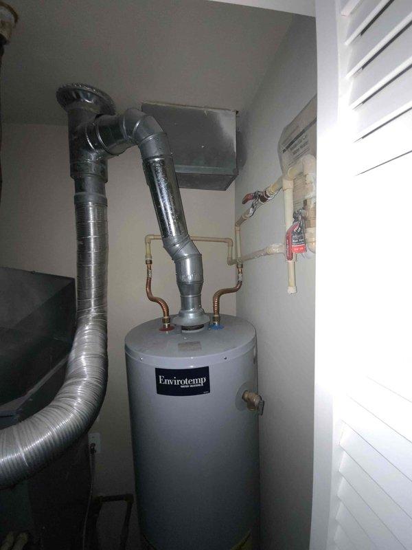 Provided estimate for replacement of 10+ year old furnace and air conditioning system located on second floor utility space. Current AC unit not operational. Quote prepared for natural gas furnace and AC replacement under BOGO promotion, with existing installation featuring compact utility room configuration including water heater and ductwork routing through slanted ceiling space.