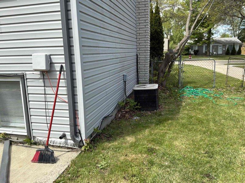 Conducted on-site evaluation of non-operational residential air conditioning system that had reached end of serviceable life at 20+ years old. Assessed existing outdoor condenser unit positioned on concrete pad against exterior wall, documented current system configuration including electrical disconnect and placement conditions. Provided comprehensive replacement estimate for new AC system to restore cooling capacity to residence.