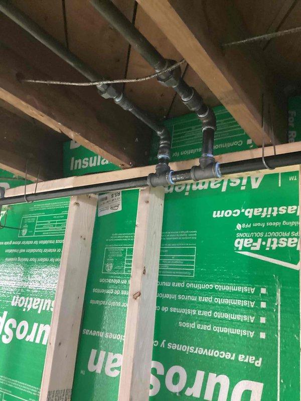 Installed new gas piping system in accordance with mechanical permit requirements. Routed copper gas line through wall cavity between framing members, securing pipe properly to structural supports. Completed installation with all connections tested and ready for inspection.