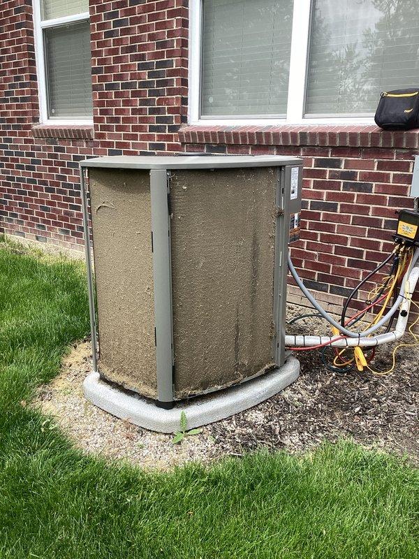 Completed annual cooling maintenance on residential split system air conditioning unit. Performed comprehensive inspection of outdoor condenser unit, which showed significant accumulation of dirt and debris on exterior panels and condensation coils. Verified refrigerant line connections and electrical components were secure and functioning properly. Inspected concrete equipment pad for stability and proper drainage. Unit operational at time of service completion.