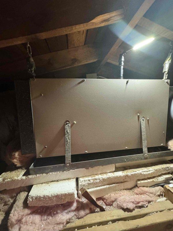 Conducted site assessment for air conditioner replacement on forty-year-old system. Performed attic inspection to evaluate existing ductwork configuration and clearance measurements for new equipment installation. Documented current HVAC system layout including horizontal plenum positioning, mounting hardware, flexible ductwork routing, and available workspace above insulated ceiling plane to determine installation requirements and equipment specifications for upcoming replacement quote.