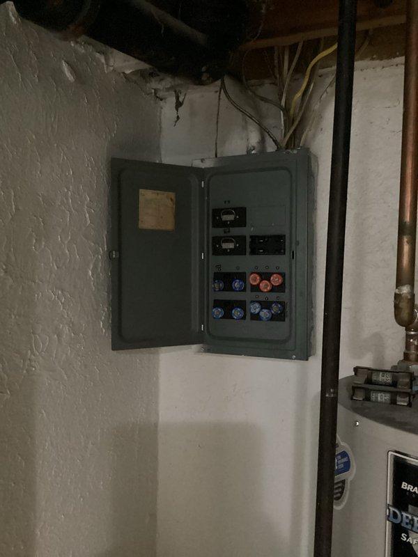 Conducted electrical panel estimate for residential property with outdated fuse-style panel experiencing multiple power outages affecting random outlets and lighting circuits throughout home. Documented existing panel condition, photographed obsolete circular fuse system with mixed fuse ratings, and assessed wiring configuration to determine scope of necessary electrical service upgrade to modern circuit breaker panel for improved safety and reliability.
