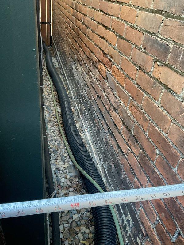 Completed installation of 1.5 ton air conditioning system with evaporator coil in rear yard location. Installed new condensing unit with proper refrigerant line connections, drainage system including corrugated discharge line positioned on gravel bed along foundation, and electrical reconnection. All mechanical and electrical permits obtained prior to installation, system tested and operational upon completion.