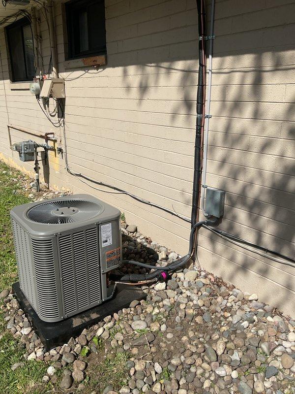 Completed installation of 1.5-ton air conditioning system with evaporator coil at rear of residential property. Installed new condensing unit on gravel pad with proper drainage, ran new electrical circuit with disconnect box and conduit mounted to exterior wall, and connected all refrigerant lines and electrical components per manufacturer specifications. System tested and confirmed operational with proper airflow and cooling capacity.
