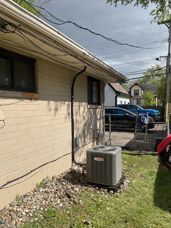 Completed installation of 1.5-ton air conditioning system with evaporator coil at rear of residential property. Installed new condensing unit on gravel pad with proper drainage, ran new electrical circuit with disconnect box and conduit mounted to exterior wall, and connected all refrigerant lines and electrical components per manufacturer specifications. System tested and confirmed operational with proper airflow and cooling capacity.