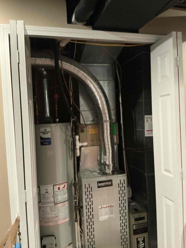 Completed estimate for air conditioning unit replacement at residential property. Existing AC system approximately 35 years old, originally installed circa 1990-1991, with no current malfunctions or operational issues reported. Customer requesting proactive upgrade due to system age. Inspected current HVAC equipment located in utility closet, including existing furnace unit and associated ductwork configuration. Documented existing system layout with flexible metal ductwork running through finished basement area with exposed ceiling joists. Provided comprehensive replacement options and recommendations for upgraded air conditioning unit compatible with current infrastructure.