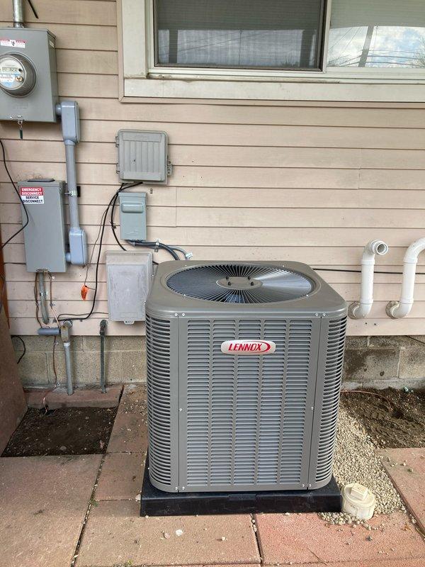 Completed full HVAC system installation including 70,000 BTU furnace, 2.5 ton Lennox air conditioning unit, humidifier, and chimney liner in rear yard location. Installed outdoor condenser unit on mounting pad with proper gravel base and concrete paver surround, routed PVC condensate drainage lines, established electrical connections with disconnect box, and reconnected all utility services. All mechanical and electrical permits obtained and system fully operational upon completion.