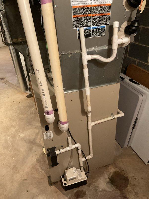 Completed warranty swap out installation of a 4-ton air conditioning system with matching evaporator coil in basement utility area. Installed Lennox vertical air handler with proper refrigerant line connections, condensate pump with drainage piping, and white PVC ventilation components. Connected electrical service, verified all mechanical and electrical connections per code requirements, and ensured proper operation of complete system including condensate removal. All permits obtained for mechanical and electrical work prior to installation. Unit properly mounted on concrete floor with all specification labels affixed and accessible for future service.
