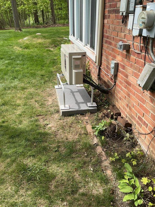 Completed callback to install level concrete pad under previously installed mini-split condenser unit. Unit was originally installed on uneven surface; returned to site to properly level and stabilize equipment per best practices. New concrete pad poured and cured, condenser repositioned and mounted on brackets to ensure proper drainage and equipment longevity. Verified all refrigerant lines, electrical connections, and condensate drainage remained secure and operational following relocation. Unit tested and confirmed running within manufacturer specifications.