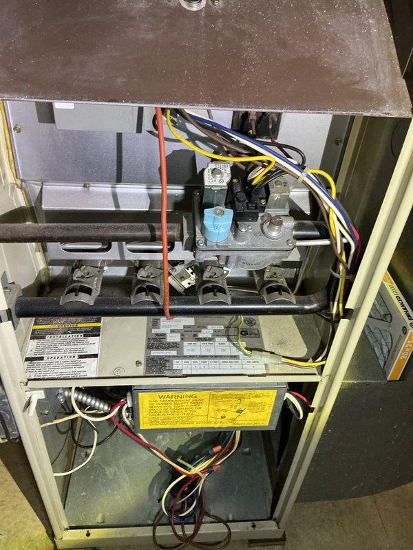 Completed AHC maintenance service on split system HVAC unit. Inspected indoor furnace components including heat exchanger, burner assembly, gas valve, and electrical connections - all found in proper working condition. Serviced outdoor condensing unit where significant mud dauber wasp nest accumulation was discovered in the electrical compartment around wiring and contactor. Removed biological debris, cleaned affected components, and verified all electrical connections were secure. System tested and returned to normal operation.