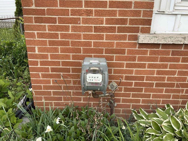 Completed comprehensive estimate for full HVAC system replacement including new furnace and air conditioning unit under promotional offer. Existing furnace is over 35 years old and property currently has no air conditioning system. Assessed installation requirements for whole house heating and cooling system, documented existing equipment conditions, and photographed exterior utility connections and potential equipment placement areas.