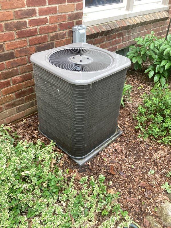 Completed annual cooling maintenance on outdoor condenser unit positioned against brick exterior. Performed comprehensive system inspection, verified operational status of fan motor and compressor, cleaned condenser coils, checked refrigerant levels, and tested electrical connections. Unit operating within normal parameters with no immediate service needs identified.