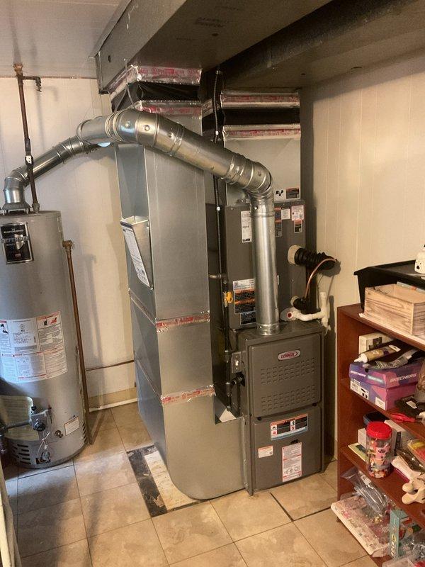 Completed full HVAC system installation including 70,000 BTU Lennox furnace and 2.5 ton air conditioning unit in residential basement utility area. Obtained mechanical and electrical permits prior to installation, installed new furnace and AC condenser unit in rear yard, connected all ductwork and refrigerant lines, and reconnected existing system components. All equipment tested and operational upon completion.