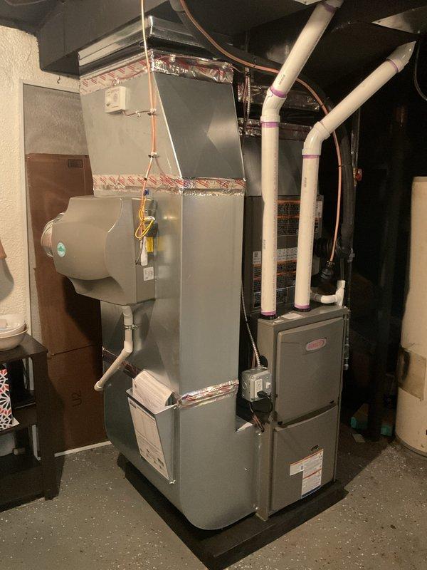 Completed full HVAC system installation including 70,000 BTU Lennox furnace and 2-ton air conditioning unit with rear placement. Installed integrated humidifier system with proper water supply connections and drainage. Ran refrigerant lines with insulation, installed PVC condensate drain and vent piping per code requirements. Connected electrical service, verified proper amperage and circuit protection. Completed all ductwork connections with proper sealing and insulation. System tested for proper operation, airflow, and refrigerant charge verified at factory specifications. All mechanical and electrical permits obtained and work performed to code compliance.
