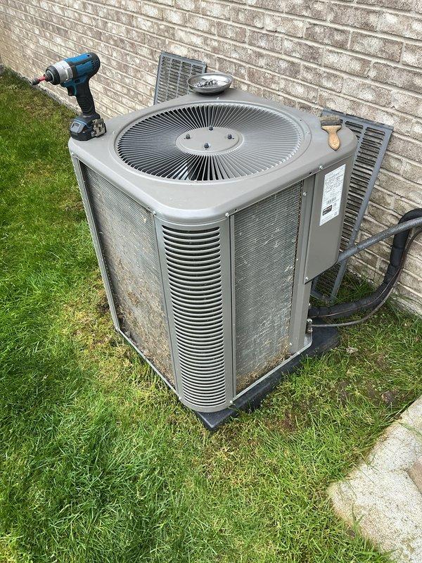 Completed annual maintenance on outdoor air conditioning condenser unit. Performed system inspection, changed air filter, and documented equipment condition with photos showing unit operating on concrete pad against exterior wall with visible wear consistent with outdoor installation.