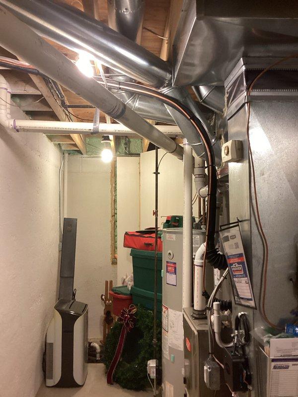 Successfully completed installation of a 3-ton air conditioning system with matching evaporator coil in residential basement mechanical room. Installed new outdoor condensing unit on left side of property and connected refrigerant lines to new indoor evaporator coil mounted to existing furnace system. Ran copper refrigerant line set through basement, secured with proper mounting brackets and insulation. Connected electrical service to new equipment and verified proper voltage and amperage. Installed condensate drain line using PVC piping integrated with existing drainage system. Performed system startup, charged refrigerant to manufacturer specifications, and verified proper airflow through ductwork. Tested all safety controls, thermostat communication, and system cycling. System operating efficiently with proper temperature split and no refrigerant leaks detected. All work performed in accordance with mechanical and electrical permits obtained prior to installation.