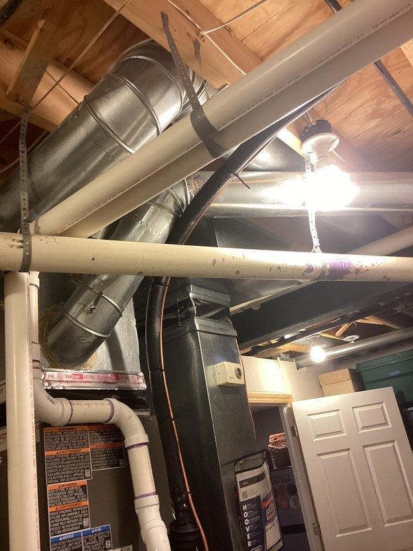 Successfully completed installation of a 3-ton air conditioning system with matching evaporator coil in residential basement mechanical room. Installed new outdoor condensing unit on left side of property and connected refrigerant lines to new indoor evaporator coil mounted to existing furnace system. Ran copper refrigerant line set through basement, secured with proper mounting brackets and insulation. Connected electrical service to new equipment and verified proper voltage and amperage. Installed condensate drain line using PVC piping integrated with existing drainage system. Performed system startup, charged refrigerant to manufacturer specifications, and verified proper airflow through ductwork. Tested all safety controls, thermostat communication, and system cycling. System operating efficiently with proper temperature split and no refrigerant leaks detected. All work performed in accordance with mechanical and electrical permits obtained prior to installation.