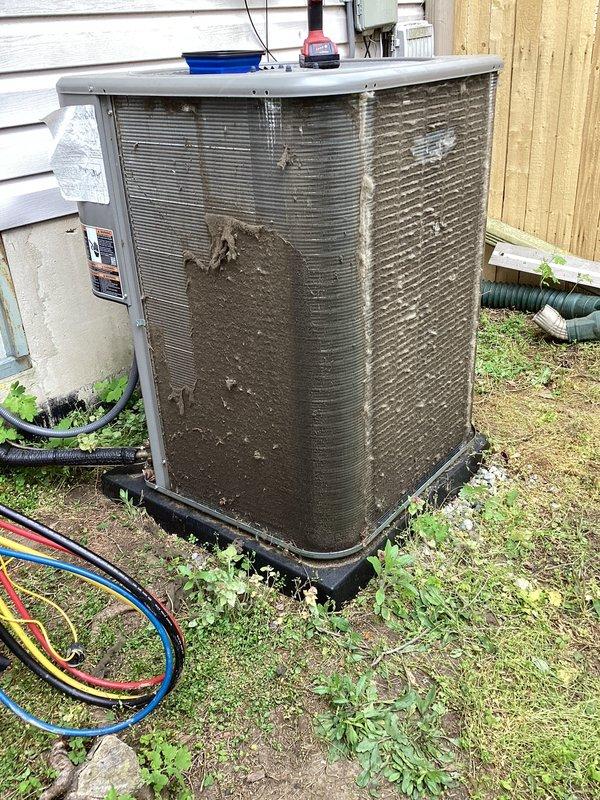 # HVAC Maintenance - ACM Completed

Performed routine Air Care Maintenance on residential split system air conditioning unit. Conducted comprehensive inspection of outdoor condenser unit, which exhibited heavy accumulation of dirt, debris, and environmental contaminants on exterior surfaces and coil fins. Cleaned condenser coils using appropriate methods to remove thick layer of brown dirt and debris that had significantly restricted airflow through the unit. Inspected fan motor assembly and top grille for proper operation. Verified refrigerant line connections and checked electrical components including exterior control box. Documented unit condition with photos showing before and after cleaning. System operational upon completion of maintenance service.