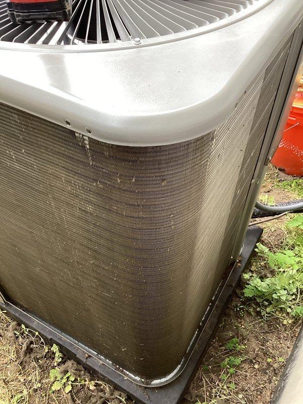 # HVAC Maintenance - ACM Completed

Performed routine Air Care Maintenance on residential split system air conditioning unit. Conducted comprehensive inspection of outdoor condenser unit, which exhibited heavy accumulation of dirt, debris, and environmental contaminants on exterior surfaces and coil fins. Cleaned condenser coils using appropriate methods to remove thick layer of brown dirt and debris that had significantly restricted airflow through the unit. Inspected fan motor assembly and top grille for proper operation. Verified refrigerant line connections and checked electrical components including exterior control box. Documented unit condition with photos showing before and after cleaning. System operational upon completion of maintenance service.