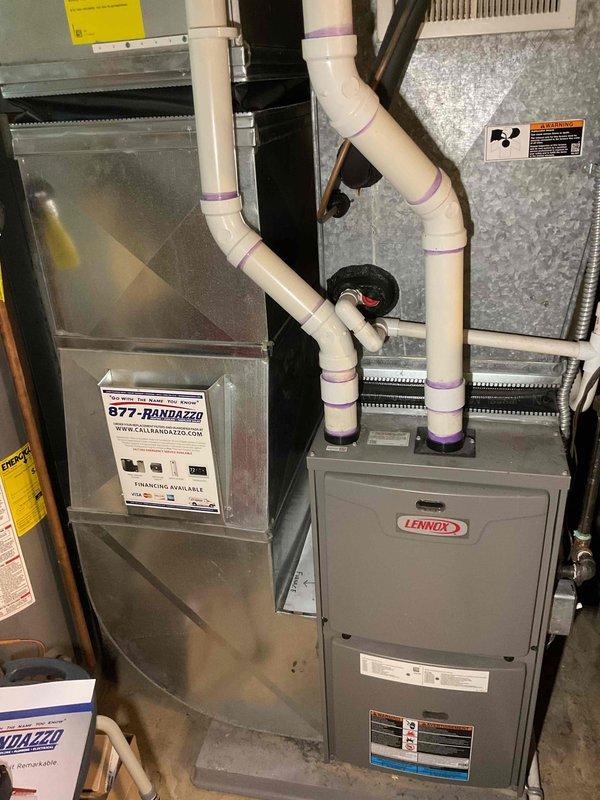 Provided estimate for air conditioning system replacement. Current outdoor unit is non-operational and of very old/unknown age. Site assessment completed with documentation of existing HVAC infrastructure including indoor air handler, furnace unit, condensate drainage system with PVC piping, refrigerant lines, and electrical components. Evaluated basement installation layout and existing ductwork configuration to determine appropriate replacement equipment specifications and installation requirements for new outdoor condensing unit.