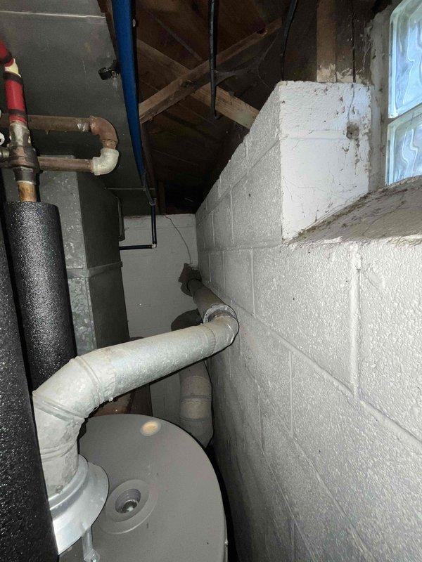 Conducted comprehensive evaluation of 30+ year old natural gas furnace and air conditioning system located in basement mechanical room. Assessed existing HVAC equipment condition, ductwork configuration, electrical service capacity, and gas line infrastructure. Documented current system specifications, measured available space for replacement equipment, and photographed existing installation including water heater proximity and utility connections. Reviewed ventilation requirements and discussed replacement options for complete furnace and A/C system upgrade to improve energy efficiency and reliability.